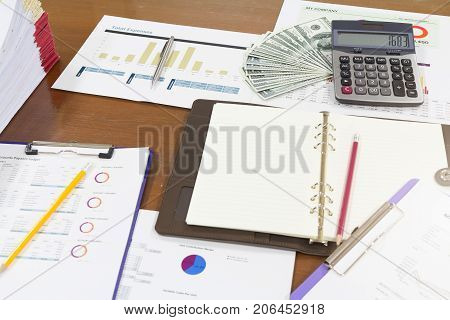 Business And Finance Concept Of Office Working,notebook ,expense Analysis Chart With Dollor Cash And