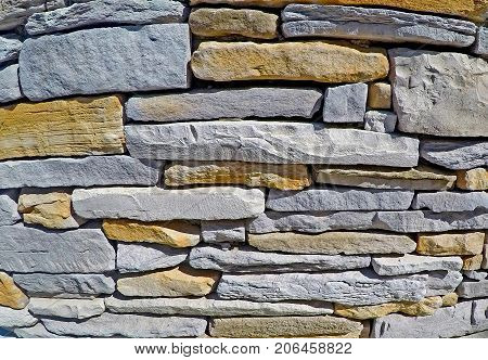Stone wall made of flagstone, building stone, dimensional stone.