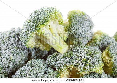 Frozen broccoli with ice isolated on white background. Macro.