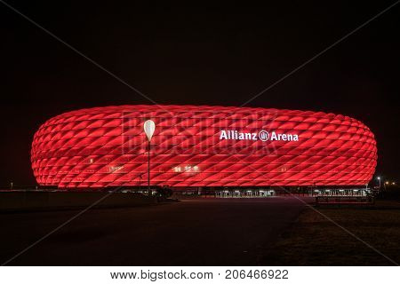 MUNICH GERMANY - 26 SEPTEMBER 2017: Allianz Arena the football stadium of FC Bayern illuminated in red at night