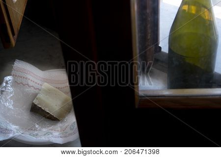 sardinian pecorino illumined from light of a window
