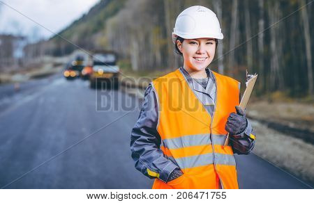 female worker road construction infrastructure repair pavement