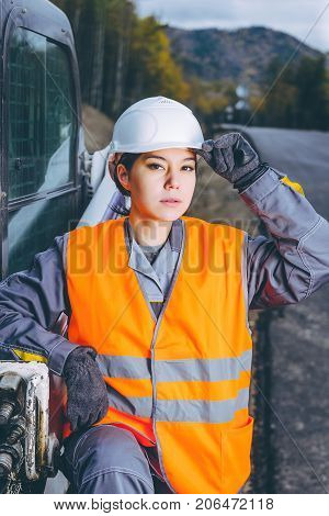 female worker road construction infrastructure repair pavement