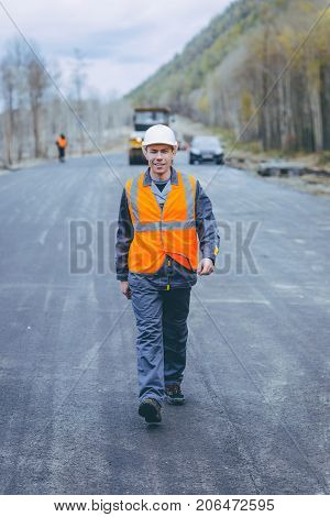 male worker road construction infrastructure repair pavement