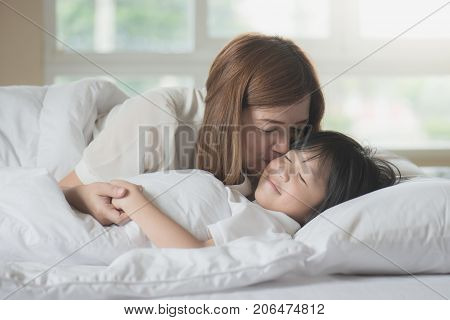 Cute Asian Child Sleeping On White Bed With Mother Care