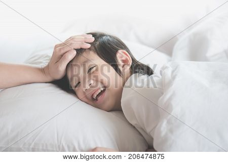 Cute Asian Child Sleeping On White Bed With Mother Care