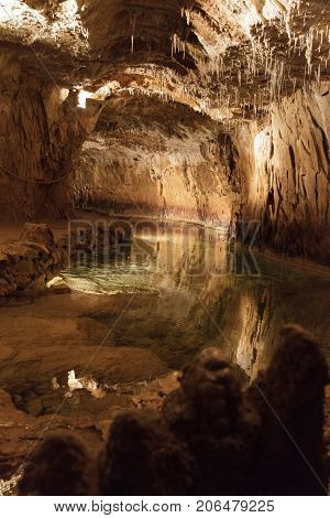 Huge cave with water reflection in france
