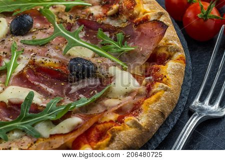 Pizza Tomato ham salad on dark background