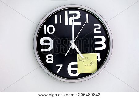 Wall Clock in a Office with a Note Over Five
