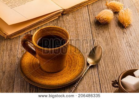 Cup Of Coffee with old books on wood background