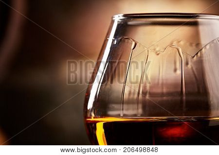 glass with cognac closeup.taste of cognac.Macro shot of cognac closeup