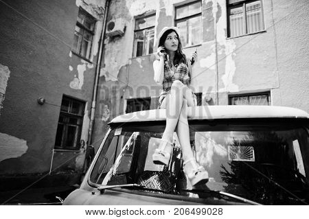 Amazing Long Legs With Hig Heels Girl Wear On Hat Sitting On Roof Of Old Retro Minivan And Listening