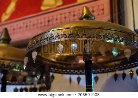 Vintage golden metal chatra at temple of Buddha's Tooth Relic. It is an auspicious symbol in Hinduism and Buddhism.