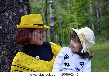 family mom and daughter resting in the forest