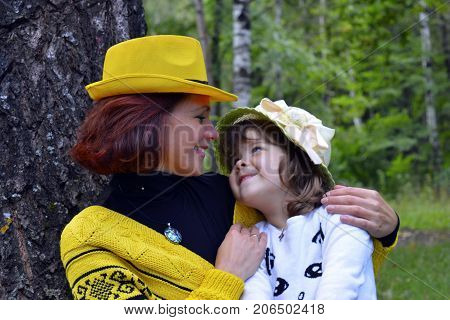 family mom and daughter resting in the forest