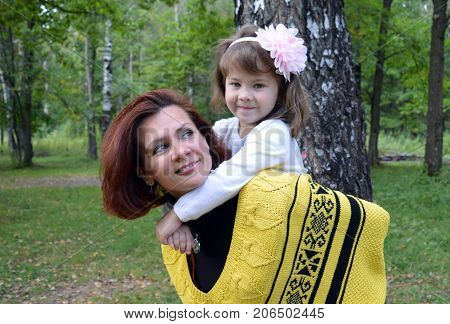 family mom and daughter resting in the forest