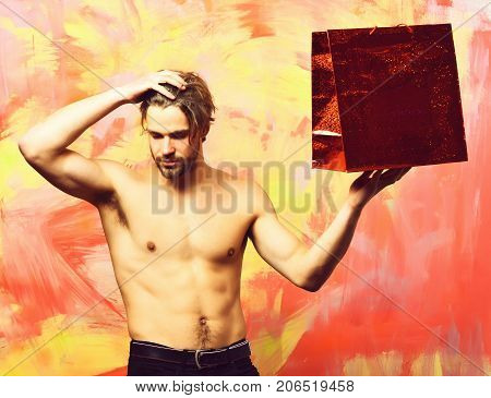 Caucasian Bearded Sexy Macho Man Holding Red Package Or Bag