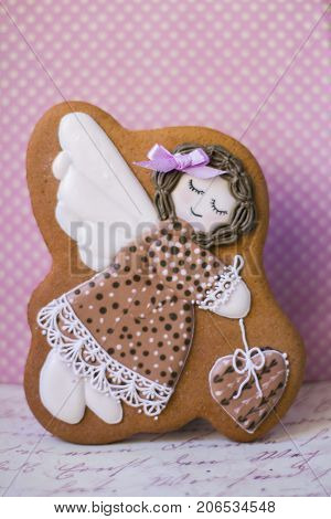 lovely girl with a heart painted with sugar icing on a stick