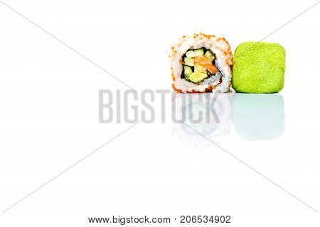 Sushi roll and vasabi isolated on white background with reflection.