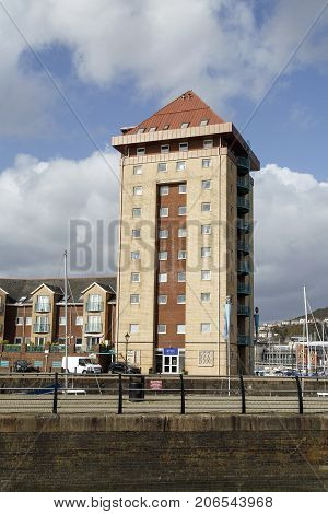 Swansea, UK: March 31, 2015: Modern quayside apartment building in the ongoing development in Swansea's Maritime Quarter SA1.