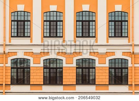 Several windows in a row on facade of urban office building front view St. Petersburg Russia