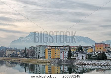 View of modern building, mountain and Salzach river in winter, Salzburg, Salzburger Land, Austria