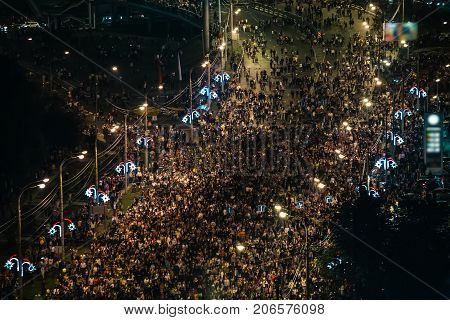 Crowd of walking people in evening, top view