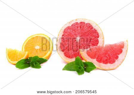 Perfect, ripe, juicy, fresh citrus fruits. Tropical, organic and exotic lemons, grapefruits and oranges with bright green leaves of mint, isolated on a white background. Multi-coloured fruits.