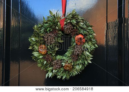 Classic christmas wreath with decorations on a door
