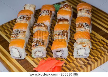 The set of rolls with ginger and wassabi on bamboo board