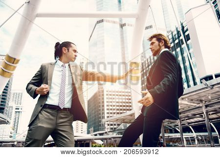 Angry businessmen push competitor from market share in imagine. Business marketing and Teamwork idea concept. Soft and split cross processing tone pinterest and instragram like process.