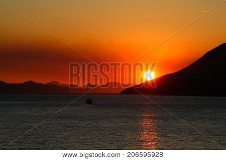 Sunset over mountains. Leaving port of Dubrovnik Croatia