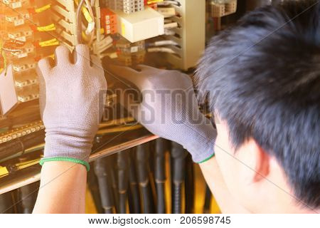 Electrical terminal in junction box and service by technician. Electrical device install in control panel for support program and control function by PLC. routine visit check equipment by technician.