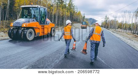 cone worker asphalting construction roller pavement repair