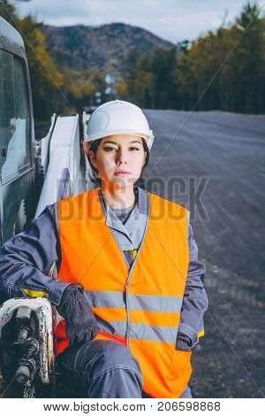female worker road construction infrastructure repair pavement