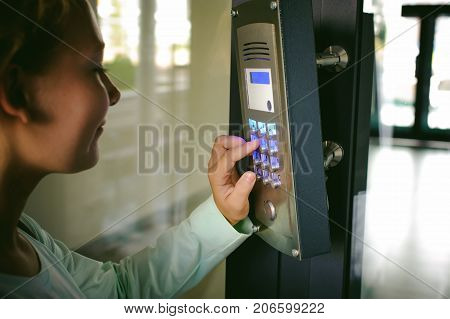 Young Blond Teenager Schoolgirl Dials The Code For A Call Over The Intercom