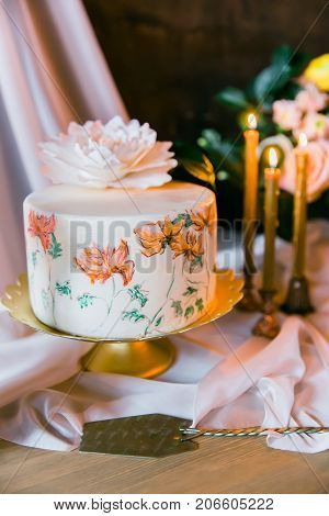 Frowers, candles and wedding painted cake. Still life