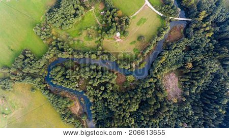Aerial view of river bend through forest. Rinza near Kocevje, Slovenia.