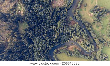 Aerial view of river bend through forest. Rinza near Kocevje, Slovenia.