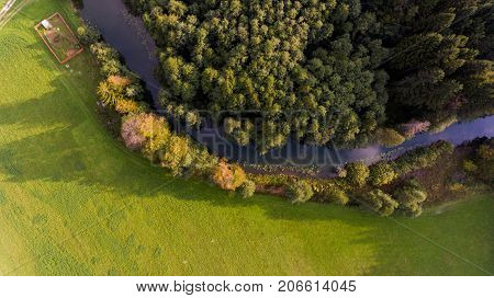 Aerial view of river bend through forest. Rinza near Kocevje, Slovenia.