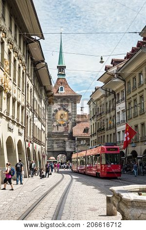 Bern Switzerland - May 26 2016: Street view on Kramgasse with red tram in the old town of Bern city. Kramgasse is a popular shopping street and medieval city centre of Bern Switzerland.