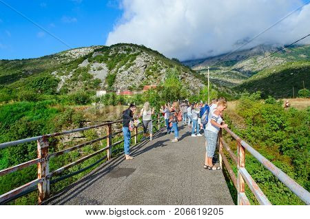 CANYON OF RIVER MORACA MONTENEGRO - SEPTEMBER 12 2017: Unknown tourists are on bridge over canyon of river Moraca Montenegro