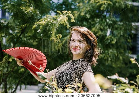 A Young Girl Walks In An Old Park.