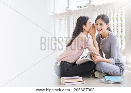 Asian Student Sitting Outside School Building Reading Book Two Asian Girls Wispering And Gossipping 