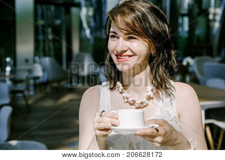 The Girl Drinks  Coffee During.