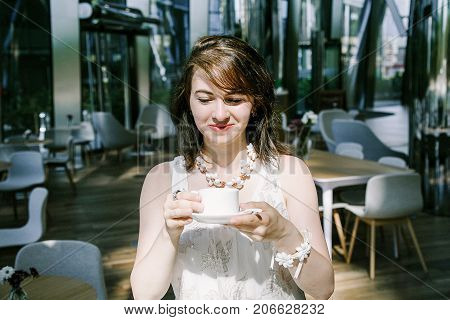 The Girl Drinks  Coffee During.
