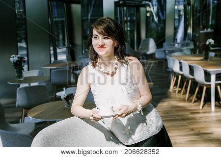 The Girl Drinks  Coffee During.