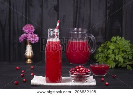 Cranberry Juice And Raw Cranberry On Black Wooden Background, Close Up