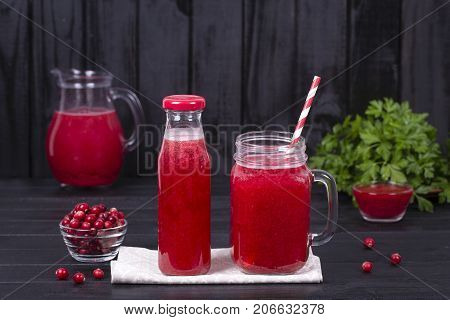 Cranberry Juice And Raw Cranberry On Black Wooden Background, Close Up