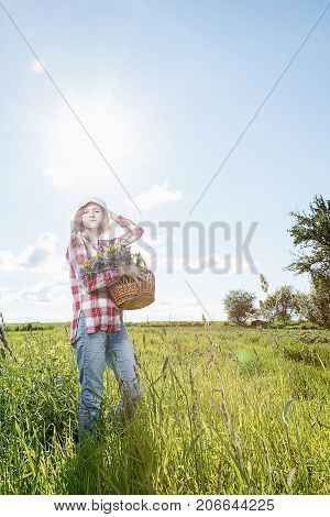 Young girl with a little rabbit. A woman holds a rabbit in her arms. Pets on a green field with a girl. Fluffy home-loving ones in the arms of a happy owner.